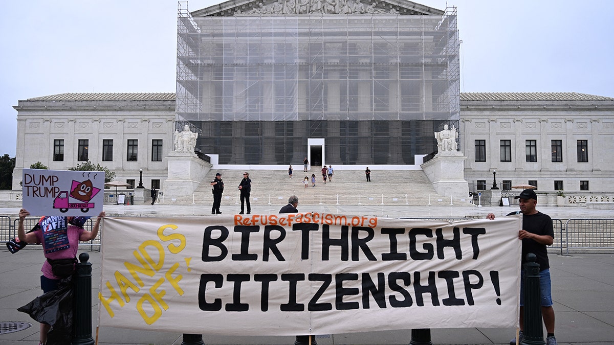 Protesters hold up birthright citizenship banner outside Supreme Court