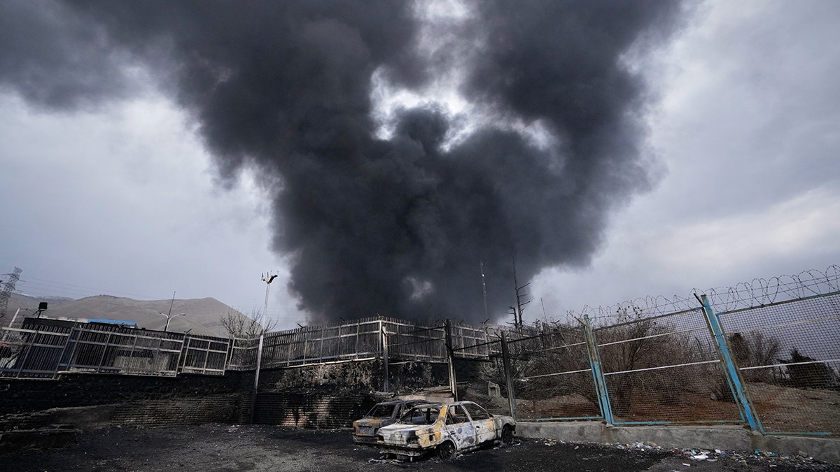 A thick plume of smoke rising from an oil storage facility in Tehran, Iran